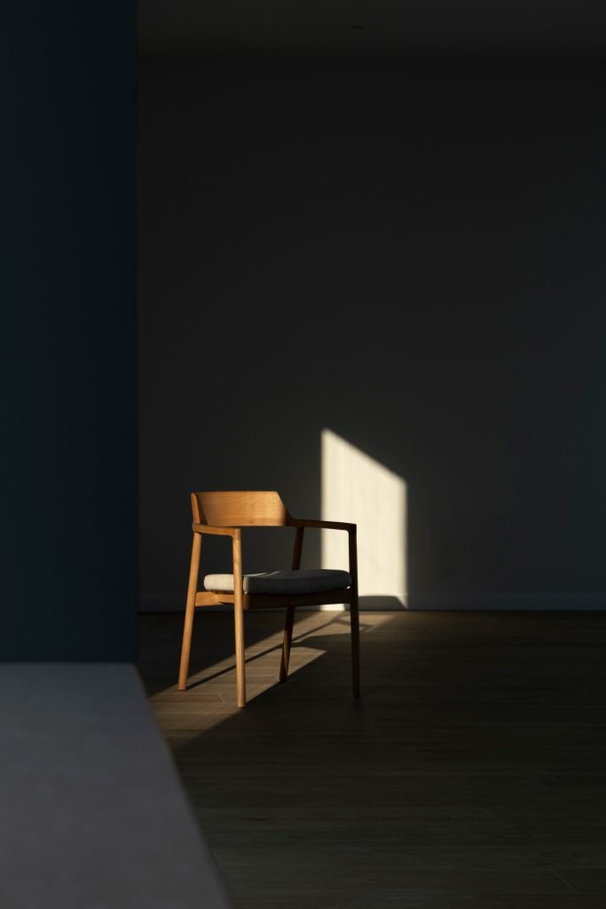 Vista de una silla en el salón iluminada por la luz natural.