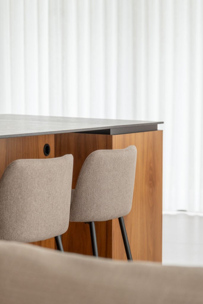 Detalle de la isla de cocina en madera con taburetes tapizados — Casa en el Mediterráneo, Fran Esbrí Studio, Castellón | Jesús Castelló